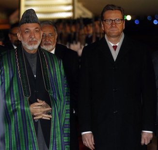 Afghan President Hamid Karzai is welcomed by German Foreign Minister Guido Westerwelle at the Cologne/Bonn military airport Afghan President Hamid Karzai is welcomed by German Foreign Minister Guido Westerwelle at the Cologne/Bonn military airport