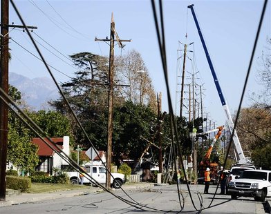 Workers repair power lines downed by heavy winds at Temple City in California Workers repair power lines downed by heavy winds at Temple City in California