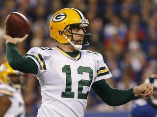 Green Bay Packers quarterback Rodgers throws a touchdown pass against the New York Giants in the first quarter during their NFL football gam
