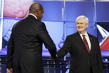 Republican presidential candidates former U.S. House Speaker Newt Gingrich shakes hands with businessman Herman Cain upon arriving at the CN Republican presidential candidates former U.S. House Speaker Newt Gingrich shakes hands with businessman Herman Cain upon arriving at the CN