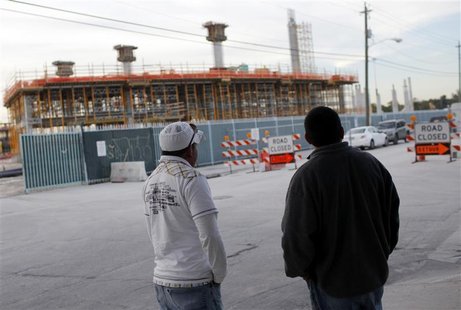 Workers wait outside the construction site of the new Florida Marlins stadium in downtown Miami, Florida Workers wait outside the construction site of the new Florida Marlins stadium in downtown Miami, Florida