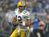 Green Bay Packers quarterback Aaron Rodgers looks for his receiver during the second half of their NFL football game against the Detroit Lio