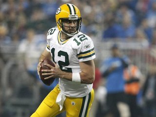 Green Bay Packers quarterback Aaron Rodgers looks for his receiver during the second half of their NFL football game against the Detroit Lio