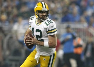 Green Bay Packers quarterback Aaron Rodgers looks for his receiver during the second half of their NFL football game against the Detroit Lio