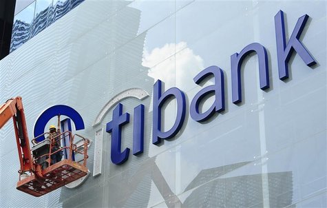 Construction workers install Citibank's neon sign on its Singapore main office at the central business district November 29, 2011. Construction workers install Citibank's neon sign on its Singapore main office at the central business district November 29, 2011.