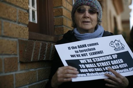 A demonstrator holds a sign during a protest by Occupy Our Homes at a foreclosed home in the Bayview section in San Francisco A demonstrator holds a sign during a protest by Occupy Our Homes at a foreclosed home in the Bayview section in San Francisco