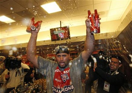 St. Louis Cardinals first baseman Albert Pujols (C) celebrates in the locker room after the Cardinals defeated the Texas Rangers to win MLB' St. Louis Cardinals first baseman Albert Pujols (C) celebrates in the locker room after the Cardinals defeated the Texas Rangers to win MLB'