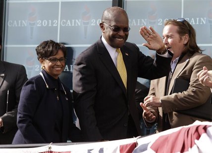 Herman Cain arrives with his wife Gloria at his side to announce that he is "suspending" his presidential campaign in Atlanta Herman Cain arrives with his wife Gloria at his side to announce that he is "suspending" his presidential campaign in Atlanta