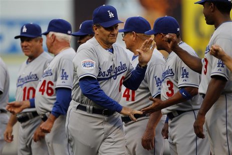 Dodgers manager Torre shakes hands with members of his team before their MLB National League baseball game in Miami Dodgers manager Torre shakes hands with members of his team before their MLB National League baseball game in Miami