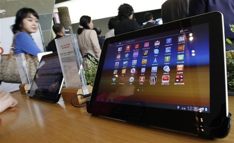 Visitors walk past Samsung Electronics' Galaxy Tab 10.1 tablets on display in Seoul Visitors walk past Samsung Electronics' Galaxy Tab 10.1 tablets on display in Seoul