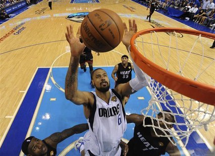 Dallas Mavericks' Chandler reaches for a rebound between Miami Heat's James and Bosh during Game 5 of the NBA Finals in Dallas Dallas Mavericks' Chandler reaches for a rebound between Miami Heat's James and Bosh during Game 5 of the NBA Finals in Dallas