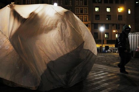 Members of Occupy Boston have fun inside a large bag at their encampment in Boston