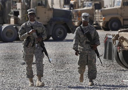 U.S. Army soldiers walk through a vehicle transport area inside Camp Adder, near Nasiriyah, Iraq U.S. Army soldiers walk through a vehicle transport area inside Camp Adder, near Nasiriyah, Iraq