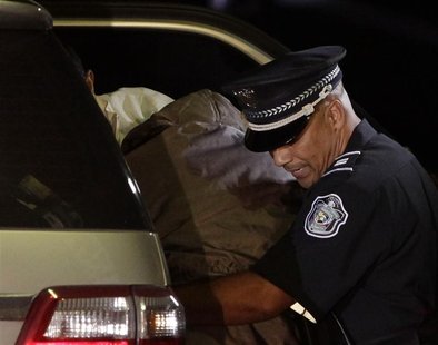 Panama's former dictator Noriega is assisted by police officers as he exits from a car upon arriving at Renacer prison outside Panama City Panama's former dictator Noriega is assisted by police officers as he exits from a car upon arriving at Renacer prison outside Panama City