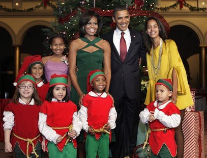 U.S. President Barack Obama and family pose with children, dressed as elves, at the "Christmas in Washington" celebration in Washington U.S. President Barack Obama and family pose with children, dressed as elves, at the "Christmas in Washington" celebration in Washington
