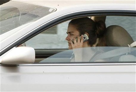 A woman talks on her cell phone while driving in Burbank A woman talks on her cell phone while driving in Burbank