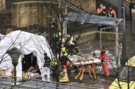 Rescuers evacuate injured people at the Place Saint Lambert square where two men threw explosives in the city center of the Belgian city of Rescuers evacuate injured people at the Place Saint Lambert square where two men threw explosives in the city center of the Belgian city of