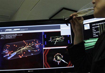 A scientist drinks a glass of champagne after the first successful collisions at full power at the CMS experience control room of the LHC at A scientist drinks a glass of champagne after the first successful collisions at full power at the CMS experience control room of the LHC at