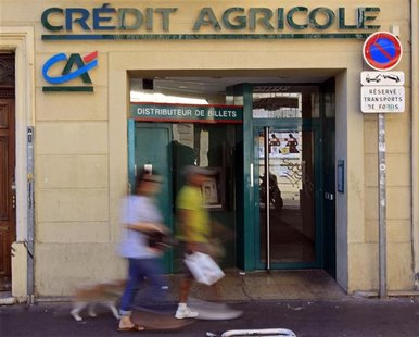 Passers-by walk in front of a branch of French bank Credit Agricole in Marseille Passers-by walk in front of a branch of French bank Credit Agricole in Marseille