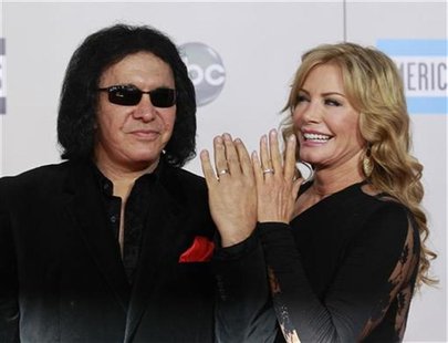 KISS band member Gene Simmons and wife Shannon Tweed show their wedding rings as they arrive at the 2011 American Music Awards in Los Angele KISS band member Gene Simmons and wife Shannon Tweed show their wedding rings as they arrive at the 2011 American Music Awards in Los Angele