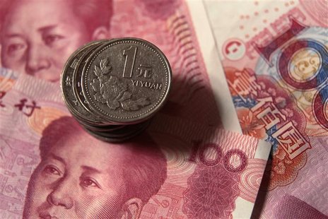 Chinese one yuan coins are placed on 100 yuan banknotes in this illustrative photograph taken in Beijing Chinese one yuan coins are placed on 100 yuan banknotes in this illustrative photograph taken in Beijing