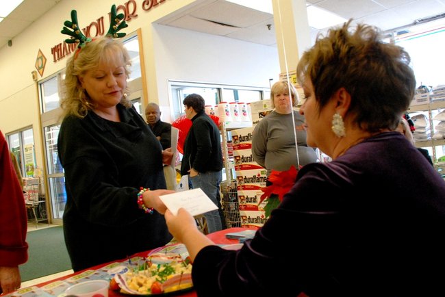 Lori Moore and the Potluck Pals descend upon Harding's on Howard St in Kalamazoo to rally support for Kalamazoo Loaves and Fishes, Dec 13, 2011.  The Pals raised $3275!