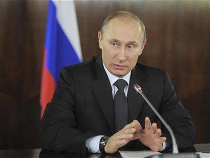 Russian PM Putin gestures during a meeting with organisers of the All-Russian People's Front in Moscow