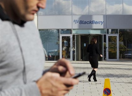 A woman walks outside Research in Motion's headquarters in Slough, southern England