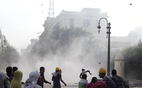 Protesters throw stones at army soldiers at a building next to cabinet offices near Tahrir Square in Cairo Protesters throw stones at army soldiers at a building next to cabinet offices near Tahrir Square in Cairo