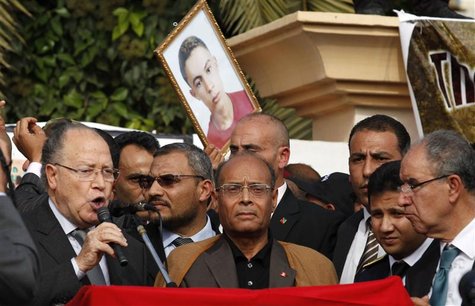 Tunisia's President Marzouki looks on as Assembly President Ben Jaafar addresses Tunisians during a ceremony marking the first anniversary o Tunisia's President Marzouki looks on as Assembly President Ben Jaafar addresses Tunisians during a ceremony marking the first anniversary o