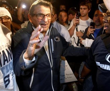 Penn State University football coach Paterno walks to his residence after speaking to a group of students rallying outside it in State Colle Penn State University football coach Paterno walks to his residence after speaking to a group of students rallying outside it in State Colle