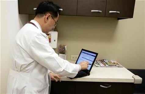 A doctor enters a note in a patient's electronic medical record A doctor enters a note in a patient's electronic medical record