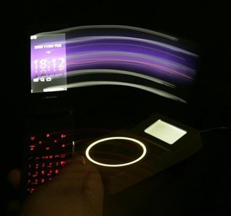 A "wallet phone" is swept over a scanning device in Tokyo November 5, 2008. A "wallet phone" is swept over a scanning device in Tokyo November 5, 2008.