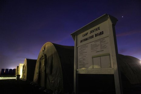 An information board stands posted near a row of tented sleeping quarters before dawn at Camp Justice at Guantanamo Bay Cuba An information board stands posted near a row of tented sleeping quarters before dawn at Camp Justice at Guantanamo Bay Cuba