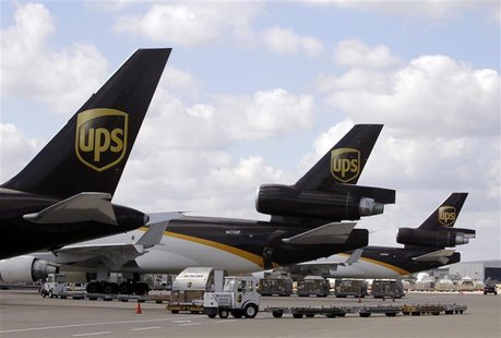 UPS employees load containers onto aircraft at World Port air hub during visit by U.S. Treasury Secretary Geithner in Louisville UPS employees load containers onto aircraft at World Port air hub during visit by U.S. Treasury Secretary Geithner in Louisville