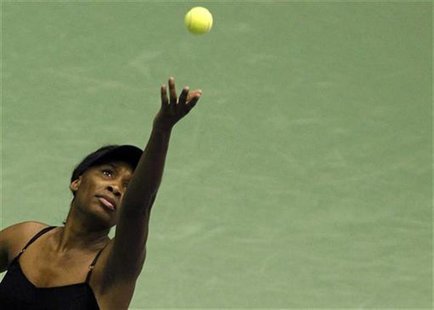 Venus Williams of the U.S. serves to Flavia Pennetta of Italy during an exhibition tennis match in Milan Venus Williams of the U.S. serves to Flavia Pennetta of Italy during an exhibition tennis match in Milan