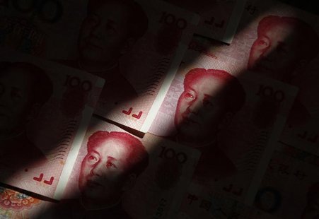 File photo of beam of light falling on Chinese 100 yuan banknotes in this photo illustration taken in Beijing File photo of beam of light falling on Chinese 100 yuan banknotes in this photo illustration taken in Beijing