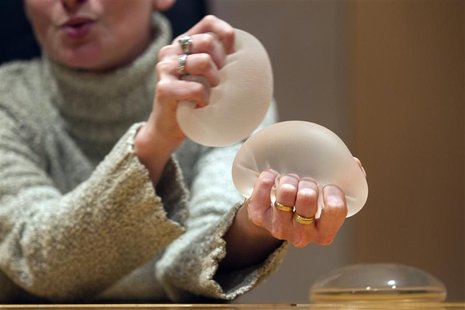 Alexandra Blachere, who heads an association of women with faulty breast implants, displays silicone gel breast implants during an interview Alexandra Blachere, who heads an association of women with faulty breast implants, displays silicone gel breast implants during an interview