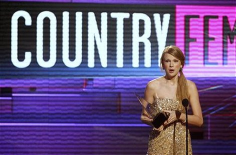 Singer Taylor Swift accepts the award for Favorite Female Country Artist at the 2011 American Music Awards in Los Angeles Singer Taylor Swift accepts the award for Favorite Female Country Artist at the 2011 American Music Awards in Los Angeles
