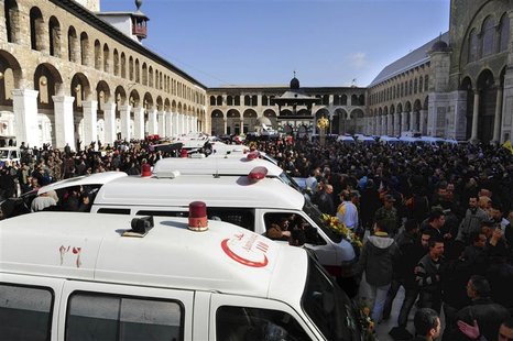 Ambulances carry the coffins of people killed at security sites on Friday in two car bomb attacks, at the Umayyad Mosque in Damascus Ambulances carry the coffins of people killed at security sites on Friday in two car bomb attacks, at the Umayyad Mosque in Damascus