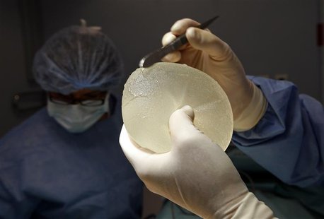 Plastic surgeon Denis Boucq displays a defective silicone gel breast implant manufactured by French company Poly Implant Prothese after he r Plastic surgeon Denis Boucq displays a defective silicone gel breast implant manufactured by French company Poly Implant Prothese after he r