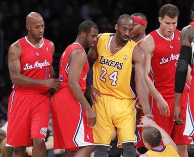 Los Angeles Lakers helps up Steve Blake as Los Angeles Clippers Chauncey Billups, Chris Paul and Blake Griffin look on in Los Angeles Los Angeles Lakers helps up Steve Blake as Los Angeles Clippers Chauncey Billups, Chris Paul and Blake Griffin look on in Los Angeles