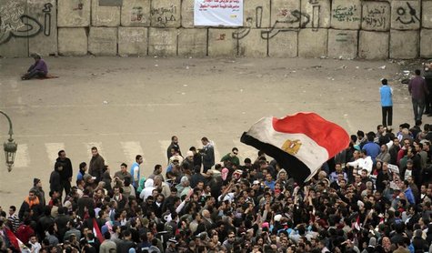 Protesters against the military council stand in front of a barricade placed by the Egyptian military near Tahrir Square in Cairo Protesters against the military council stand in front of a barricade placed by the Egyptian military near Tahrir Square in Cairo