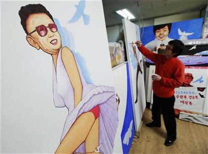 A North Korean defector and artist paints next to another work of his titled "Marilyn Monroe", which satirizes North Korean leader Kim Jong- A North Korean defector and artist paints next to another work of his titled "Marilyn Monroe", which satirizes North Korean leader Kim Jong-