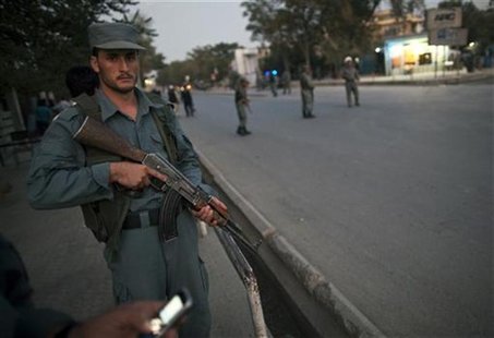 Afghan policeman keeps watch near the house of the head of Afghanistan's High Peace Council Burhanuddin Rabbani after a blast in Kabul