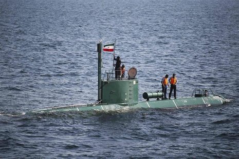 Military personnel place a flag on a submarine during the Velayat-90 war games by the Iranian navy in the Strait of Hormuz in southern Iran Military personnel place a flag on a submarine during the Velayat-90 war games by the Iranian navy in the Strait of Hormuz in southern Iran