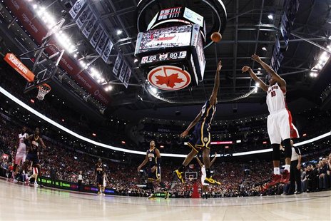 Toronto Raptors' DeRozan puts up a three-point-shot against Indiana Pacers' George during their NBA game in Toronto Toronto Raptors' DeRozan puts up a three-point-shot against Indiana Pacers' George during their NBA game in Toronto