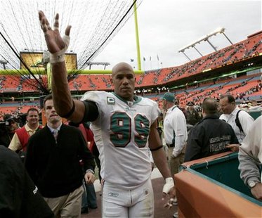 Miami Dolphins linebacker Jason Taylor waves as he leaves the field in Miami Miami Dolphins linebacker Jason Taylor waves as he leaves the field in Miami