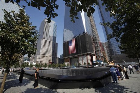 Visitors look at panels containing the names of the victims of the attacks, as well as one of the memorial pools, on the first day that the Visitors look at panels containing the names of the victims of the attacks, as well as one of the memorial pools, on the first day that the