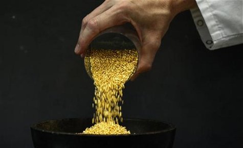 An employee empties a cup of gold granules at the Austrian Gold and Silver Separating Plant 'Oegussa' in Vienna An employee empties a cup of gold granules at the Austrian Gold and Silver Separating Plant 'Oegussa' in Vienna